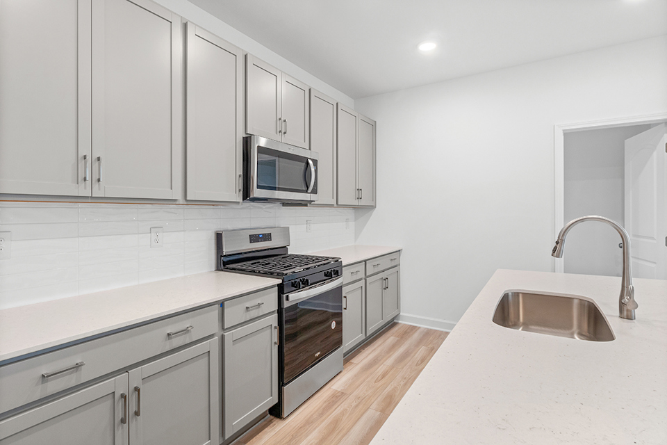 A kitchen with white cabinets.
