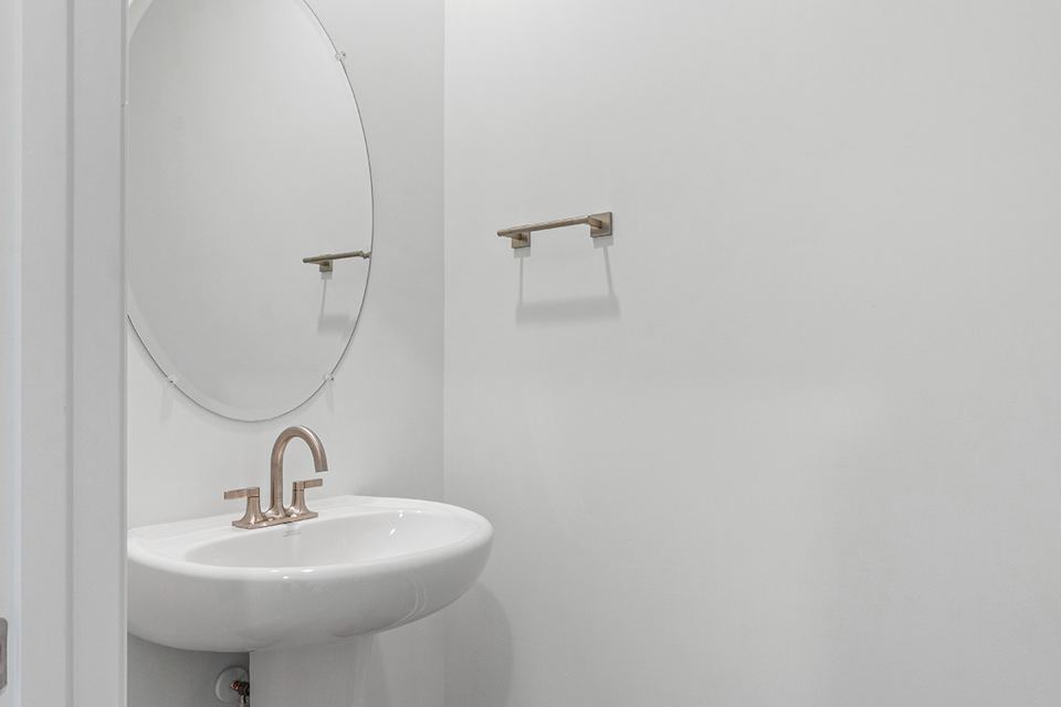 A bathroom with a mirror and sink.