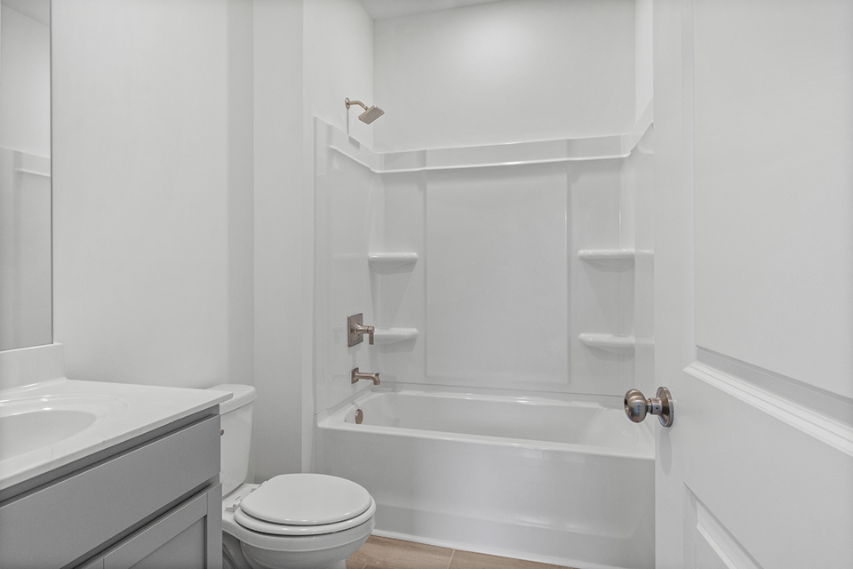 A bathroom with a tub toilet and sink.