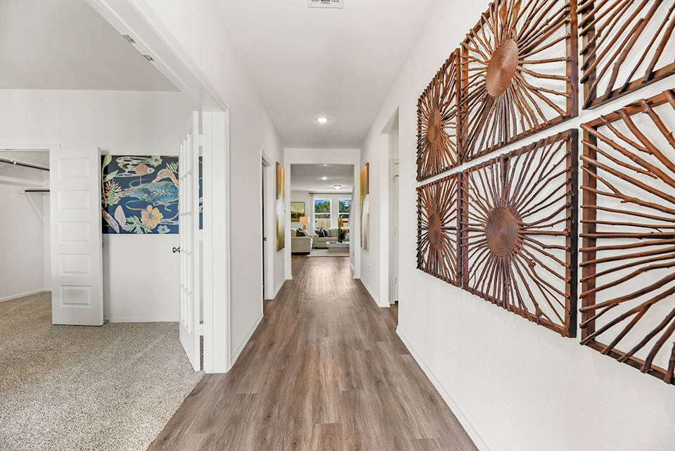 A hallway with a wood floor.