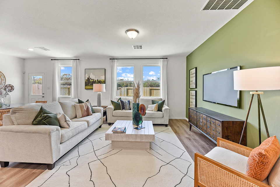 A living room with a large television.