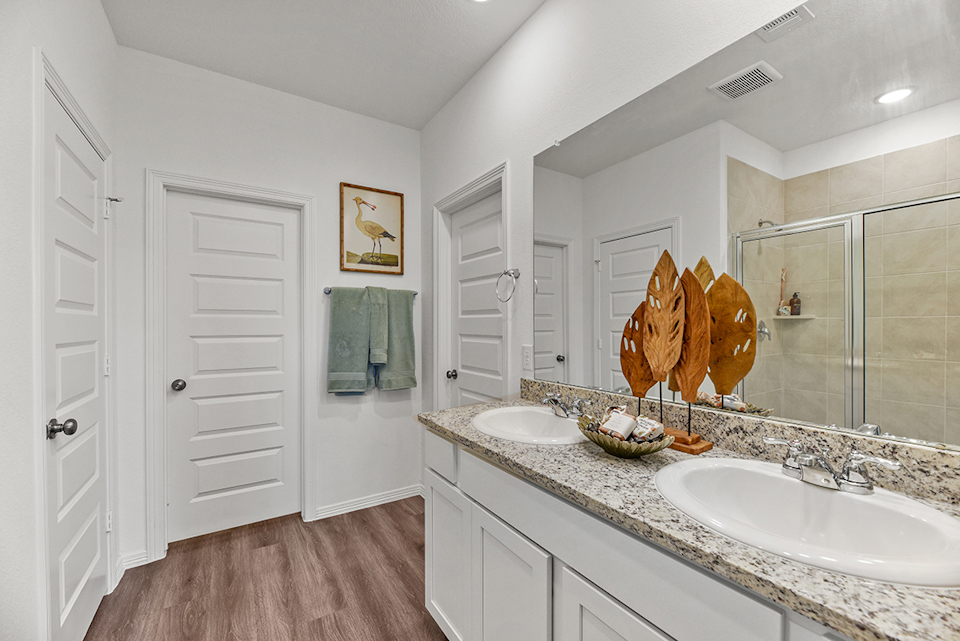 A bathroom with a large mirror.