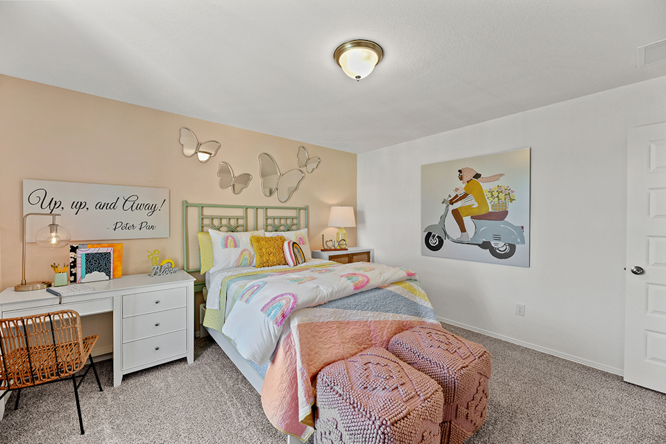 A bedroom with a bed and a chair.