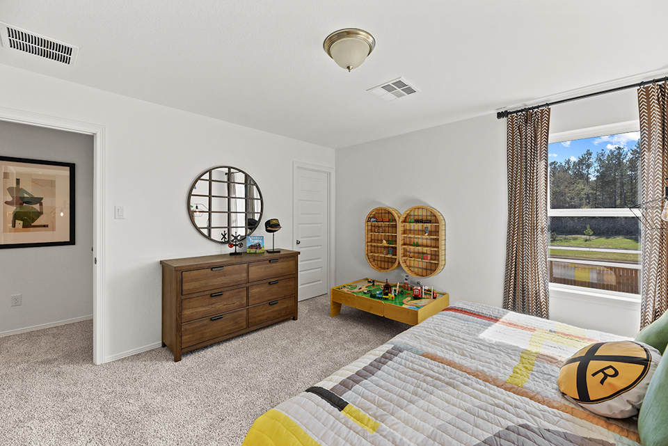 A bedroom with a large mirror.