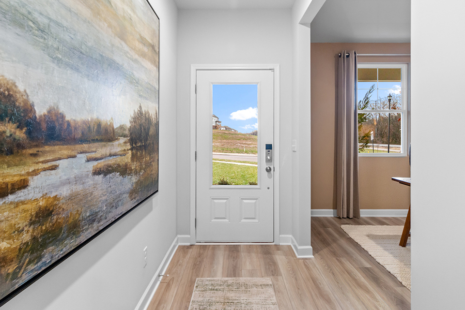 A room with a large painting on the wall.