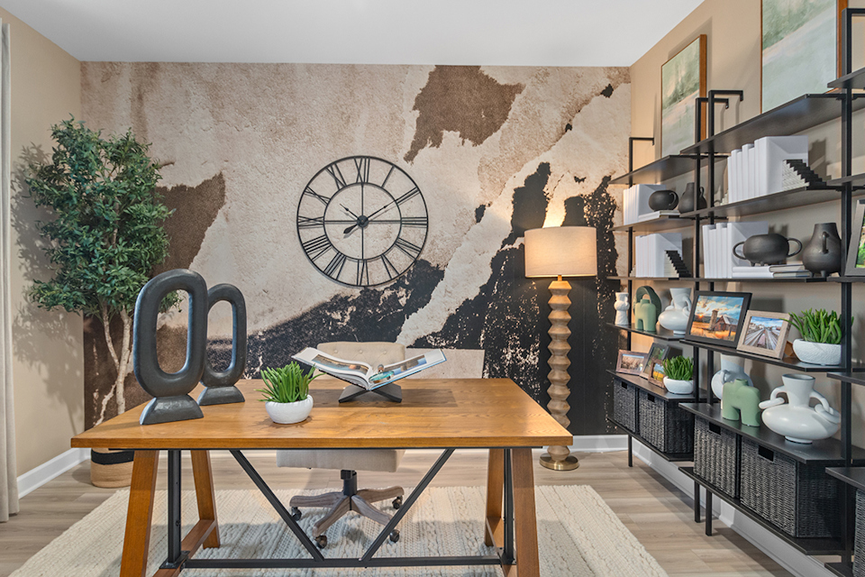 A table with a lamp and books on it in a room with shelves.