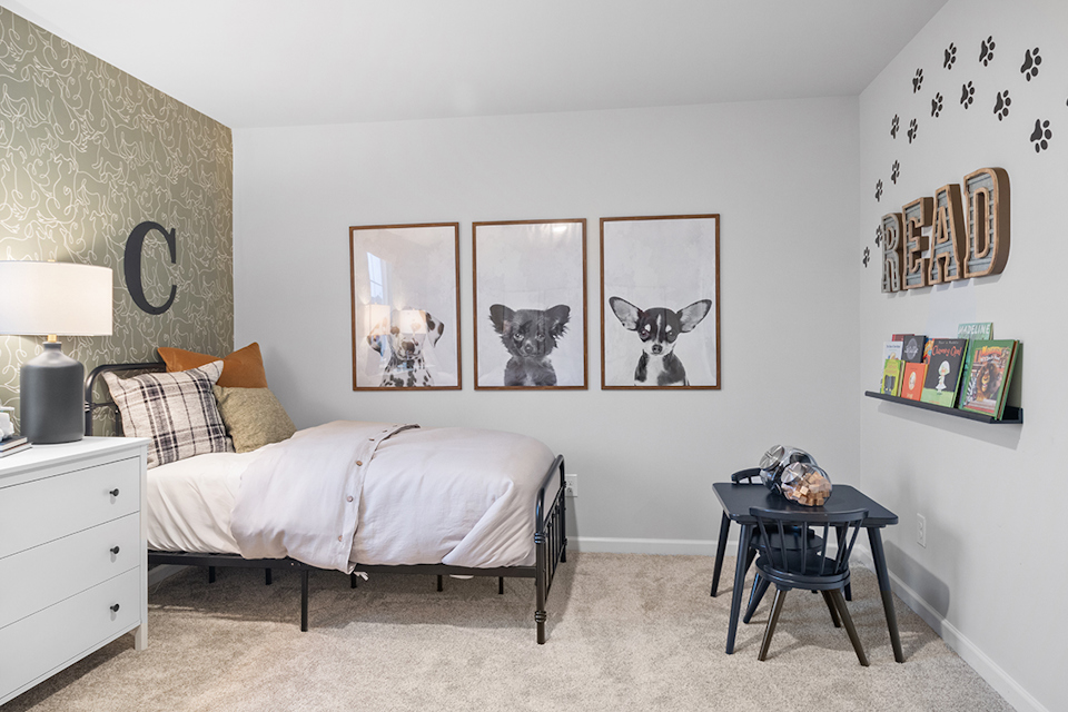 A bedroom with a bed and art on the wall.