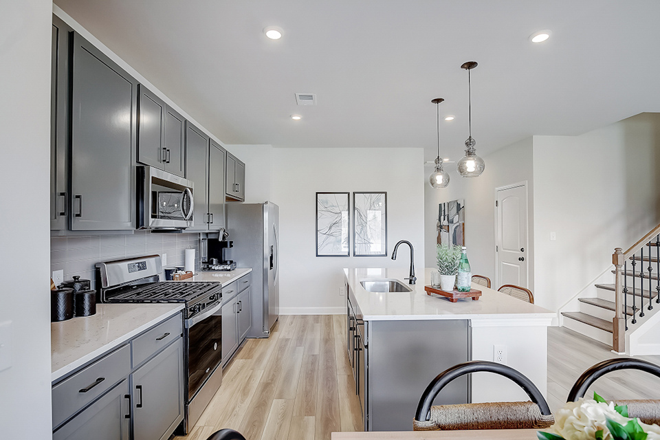 A kitchen with white cabinets.