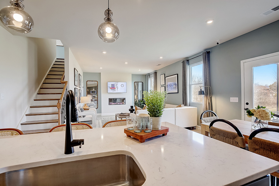 A large kitchen with a staircase.