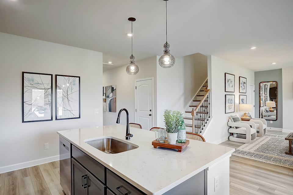 A kitchen with a sink and a mirror.