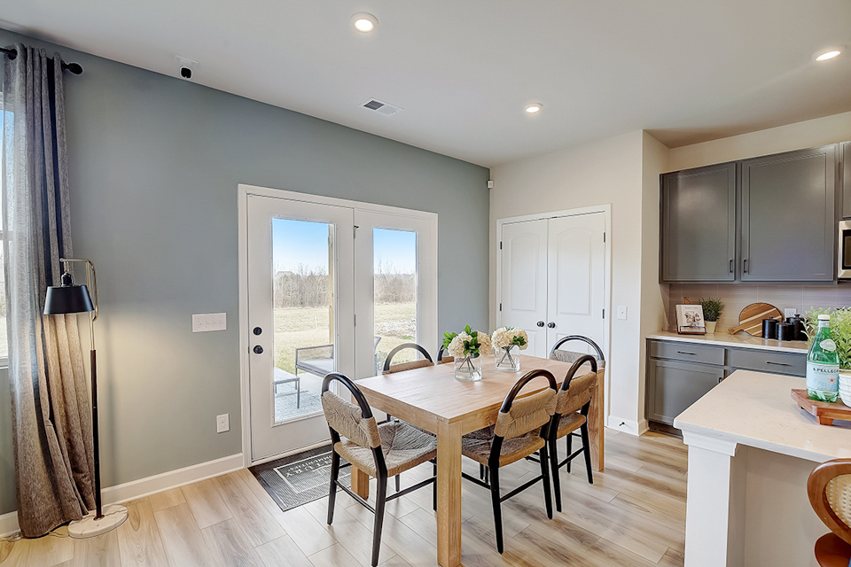 A dining room with a table and chairs.