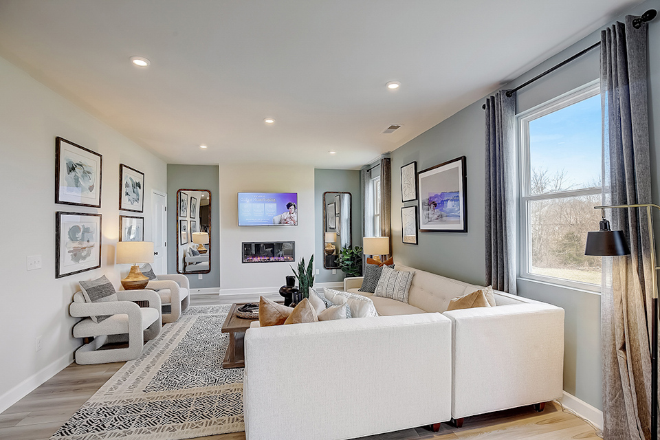 A living room with a white couch and a white table.