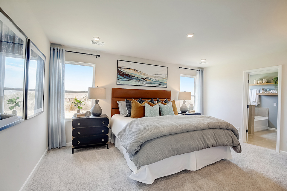A bedroom with a bed and a desk.