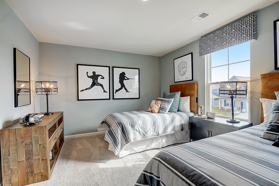 A bedroom with a bed and a window.