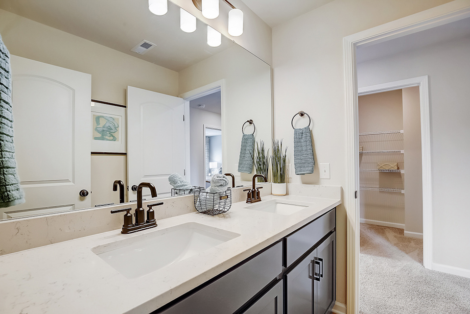 A bathroom with a sink and a mirror.