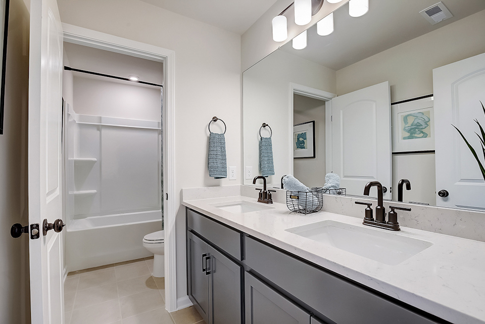 A bathroom with a sink and a shower.