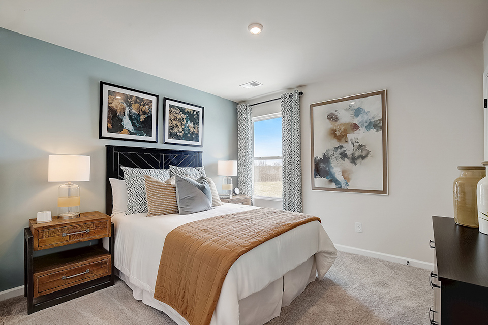 A bedroom with a large window.