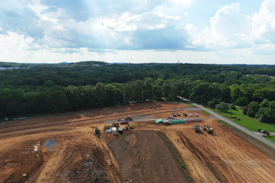 A dirt road with cars on it.