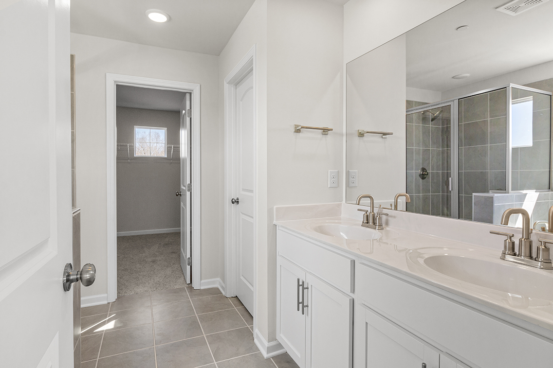 A bathroom with a large mirror.