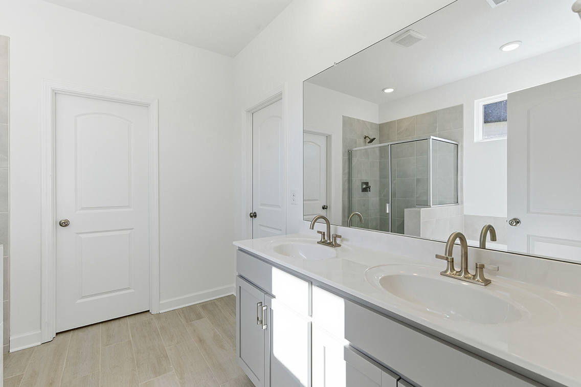 A bathroom with a large mirror.