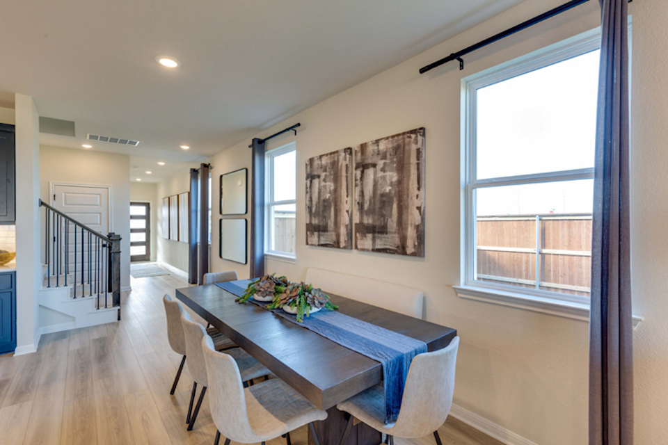 A dining room with a table and chairs.