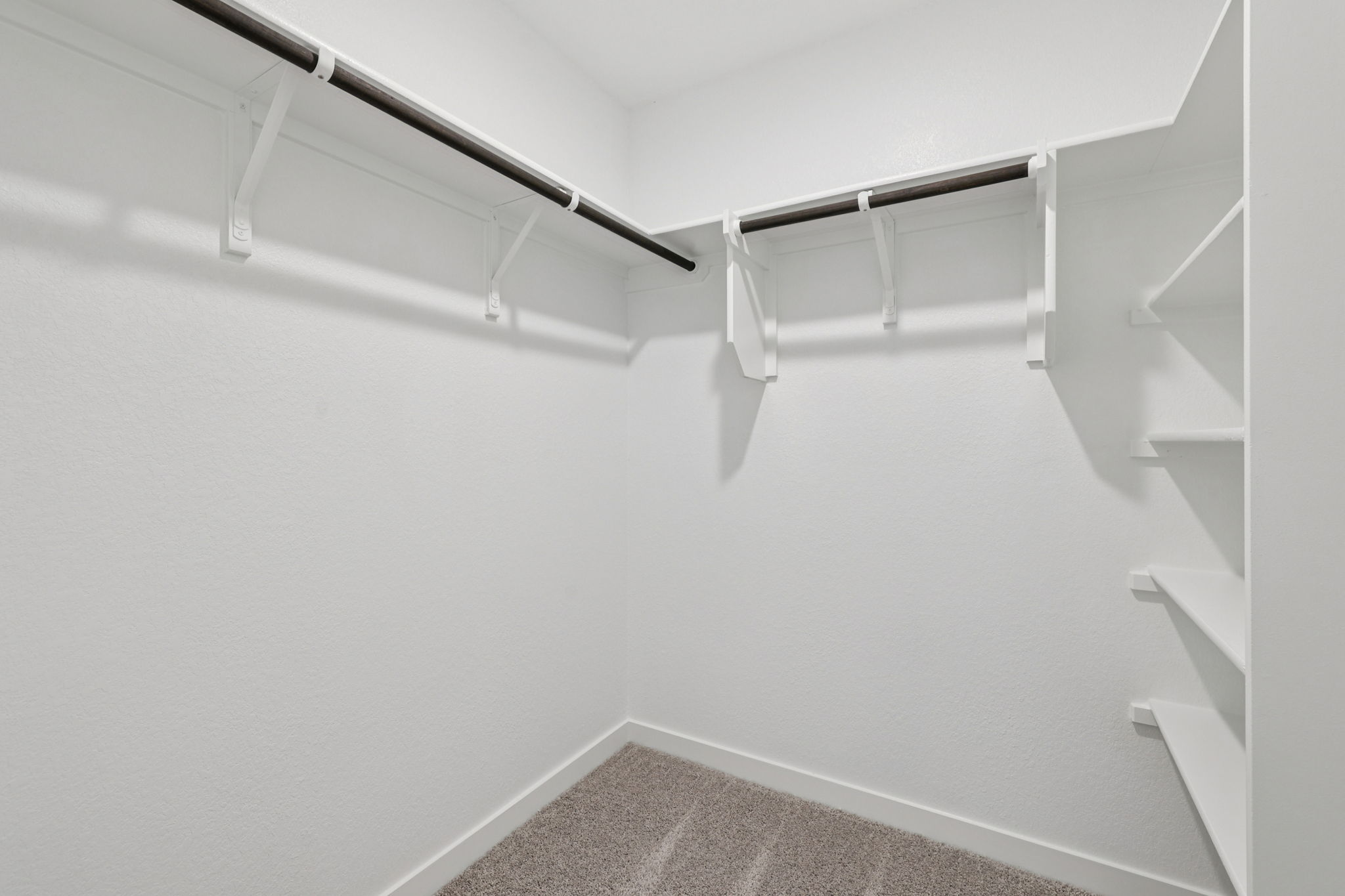 A white staircase with a metal railing.