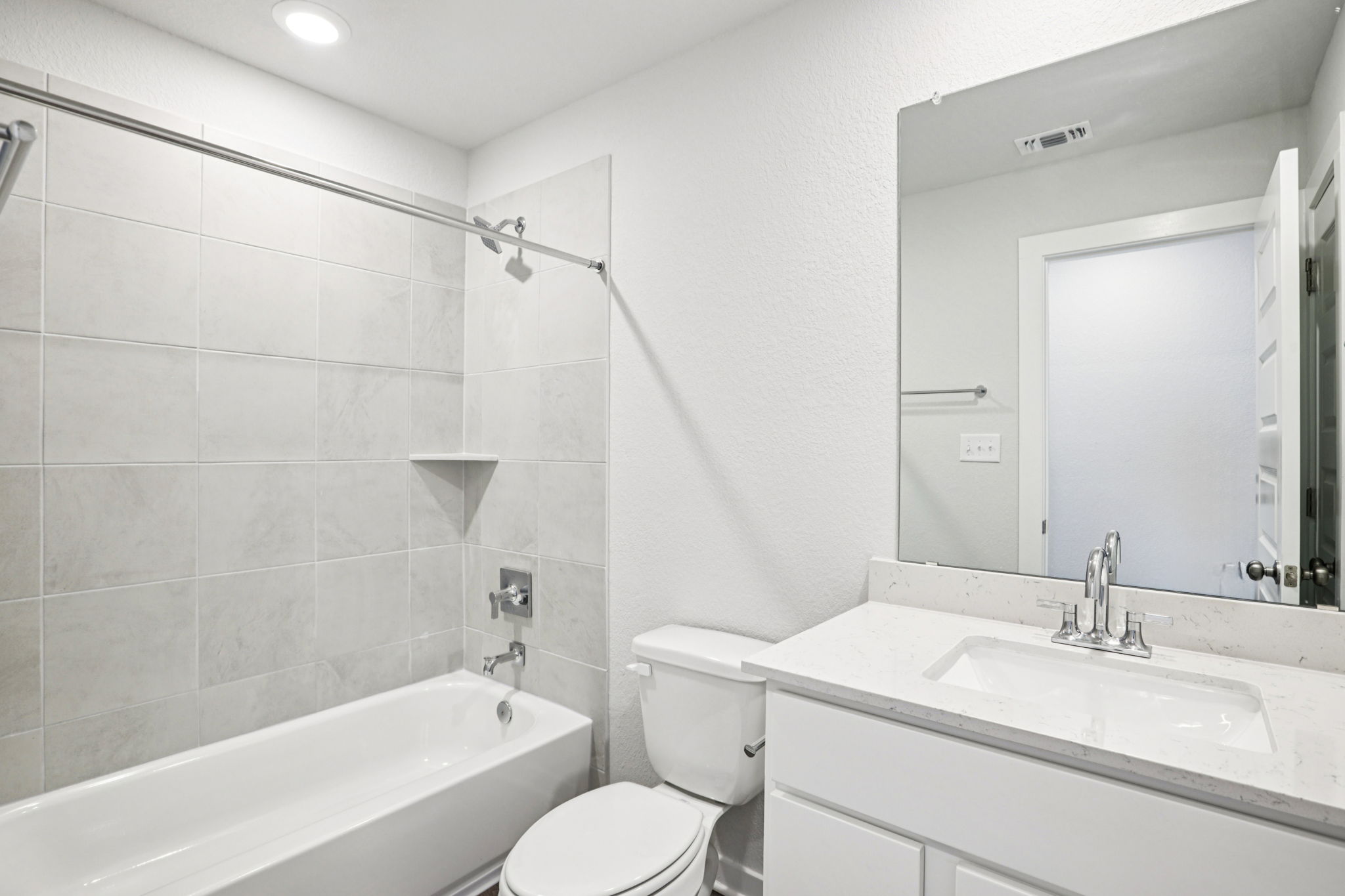 A bathroom with a tub sink and toilet.