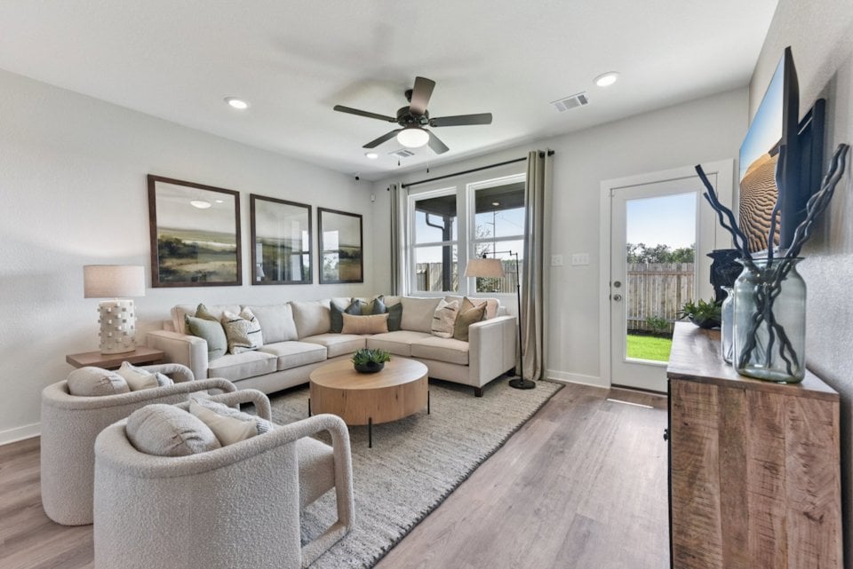 A living room with a large television and a couch.