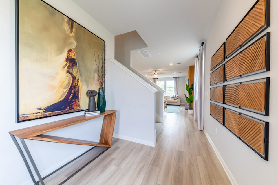 A room with a wood floor and a painting on the wall.