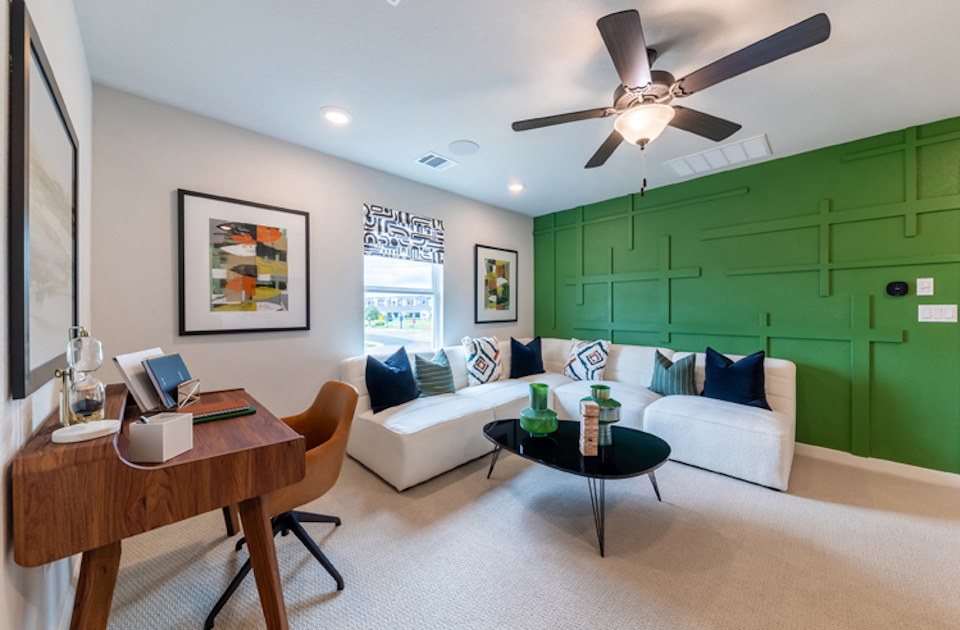 A living room with a green wall.