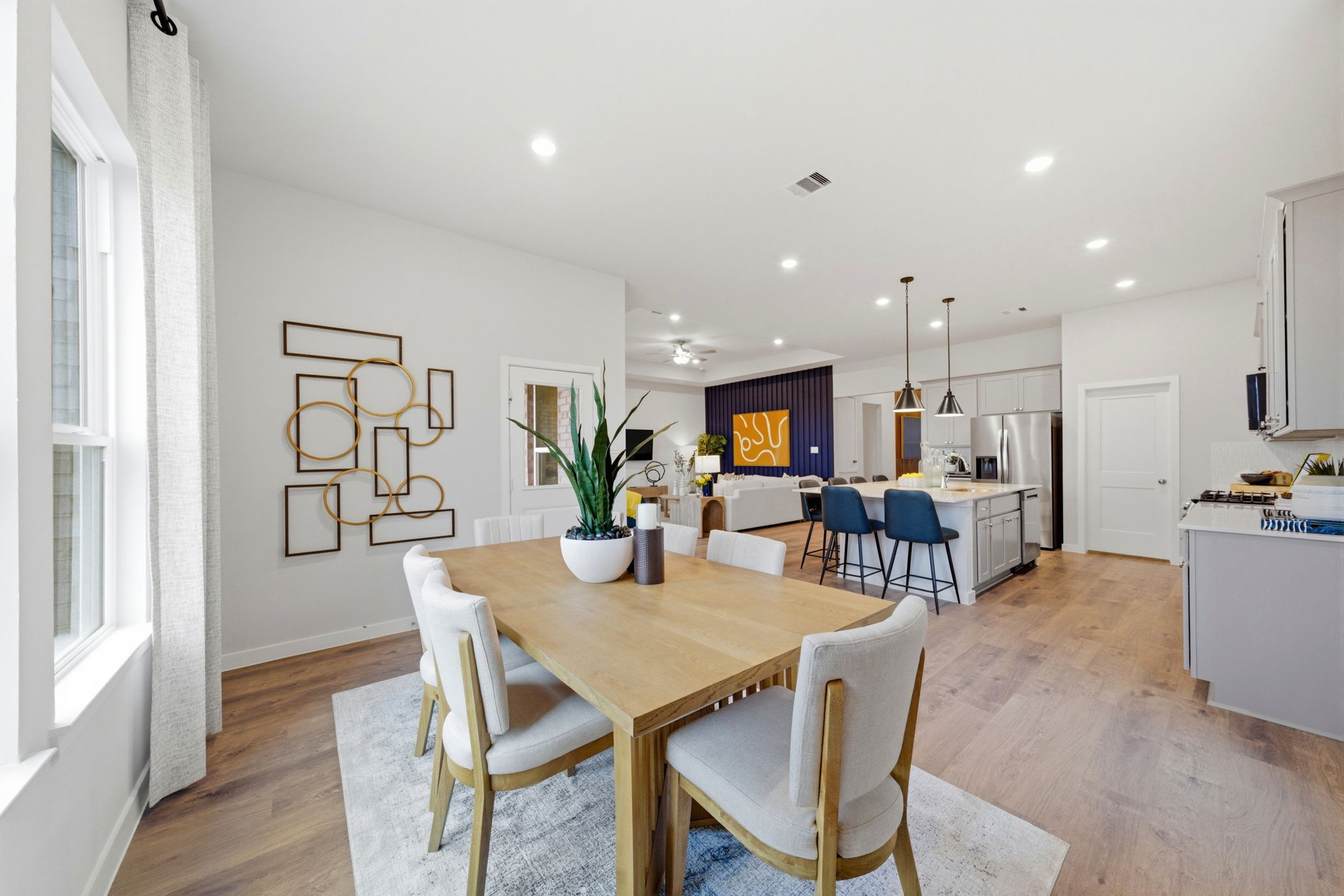 A dining room with a table and chairs.