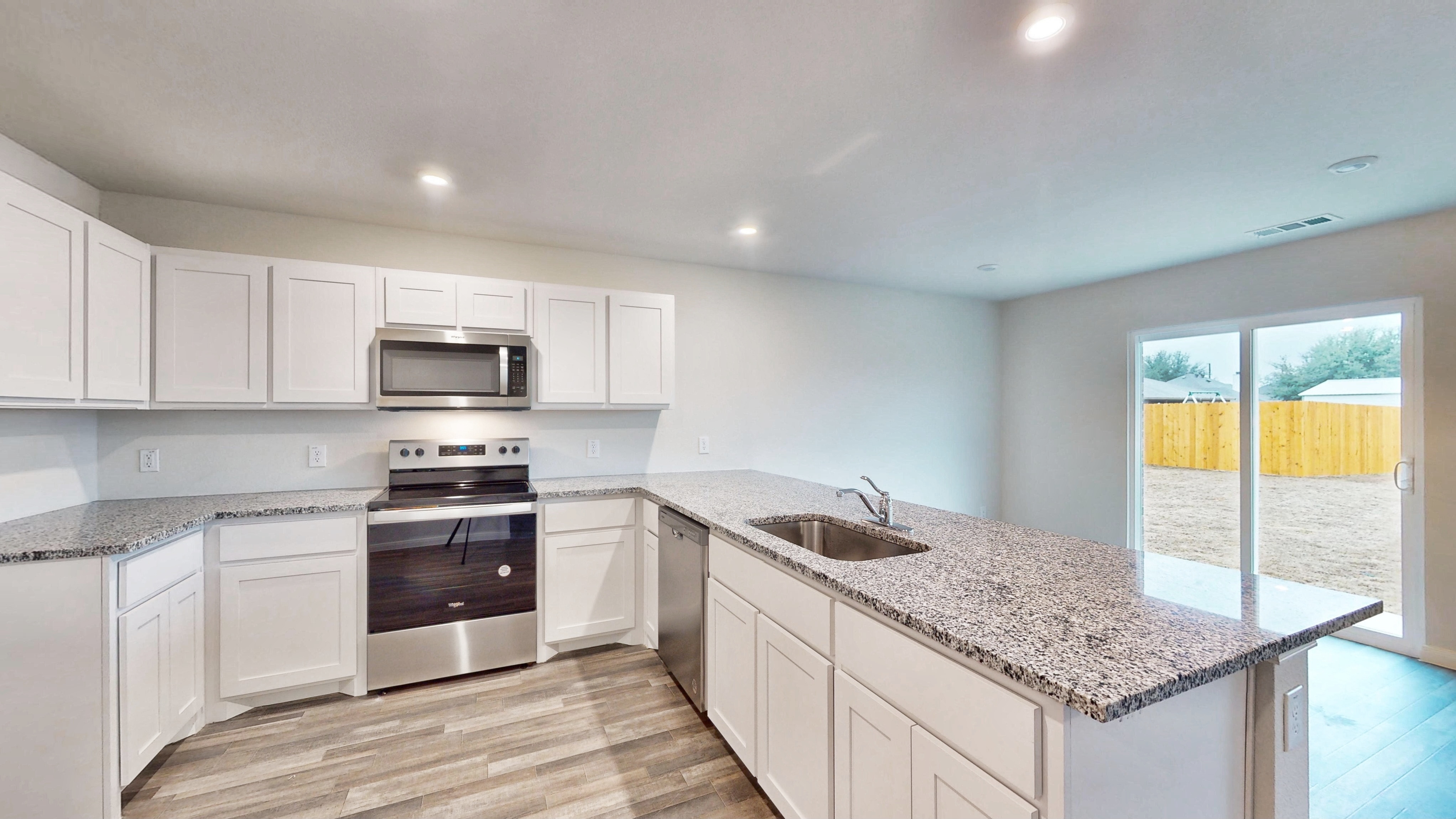 A kitchen with white cabinets.