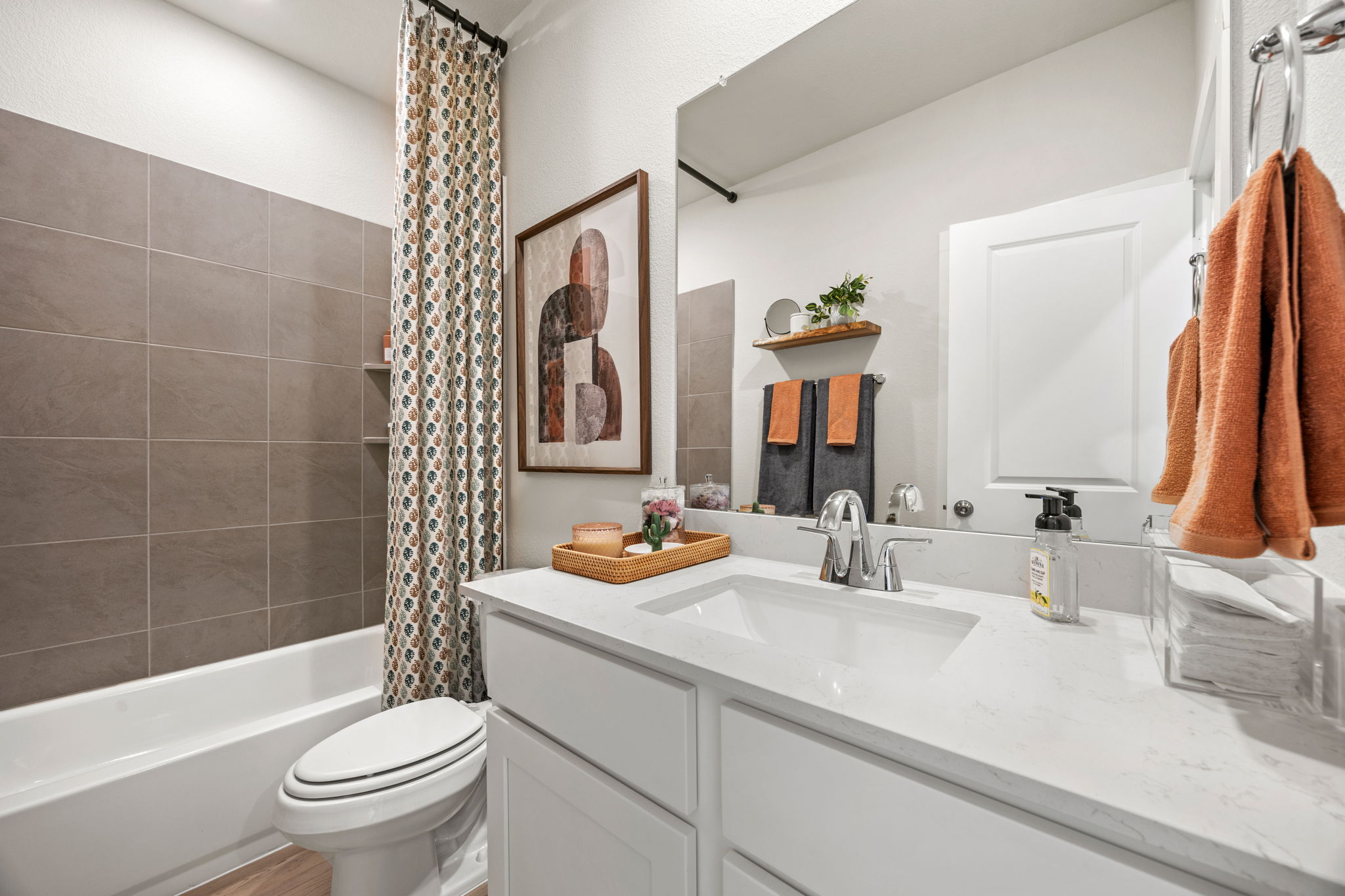 A bathroom with a tub sink and toilet.