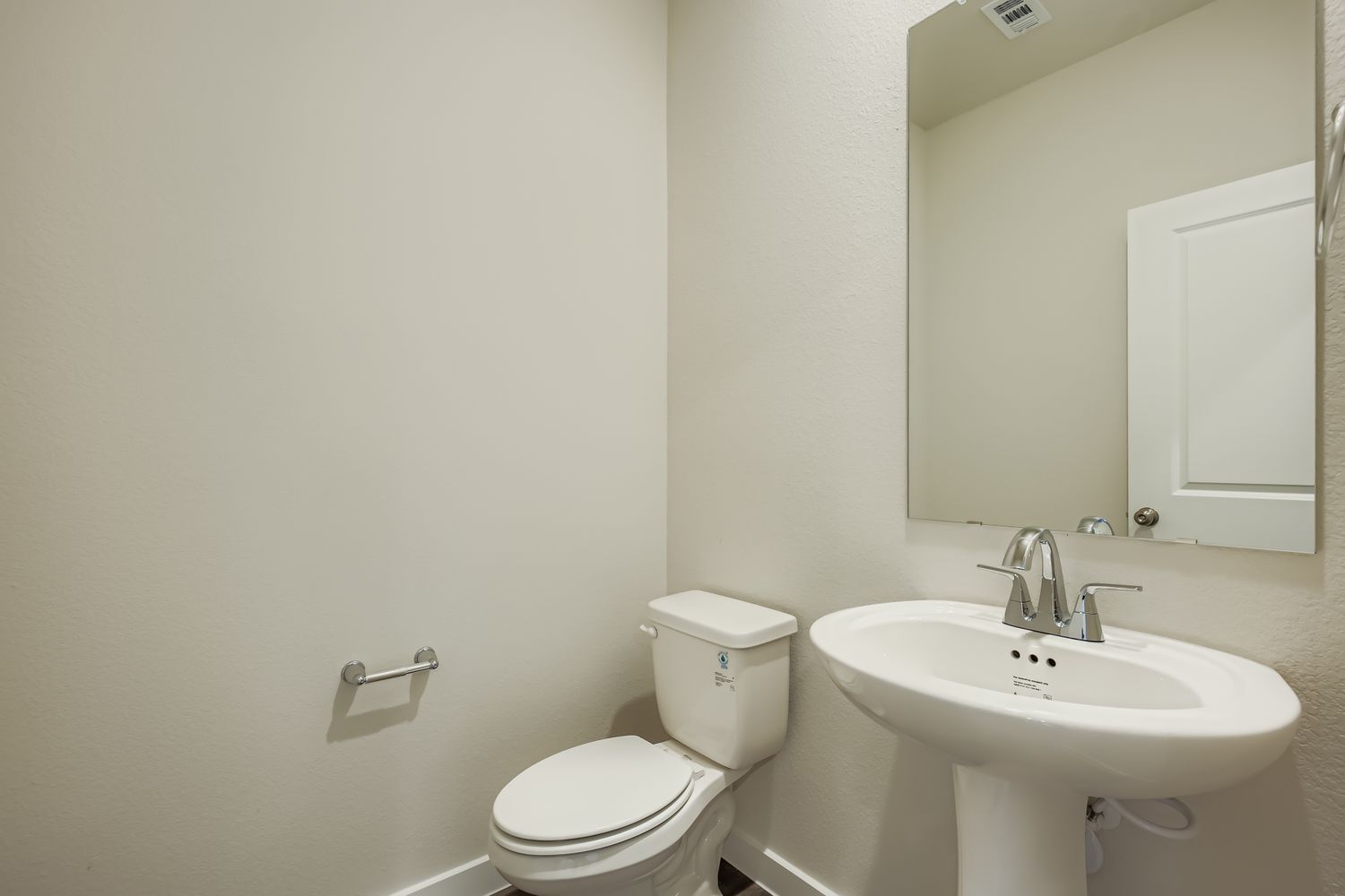 A bathroom with a toilet and sink.