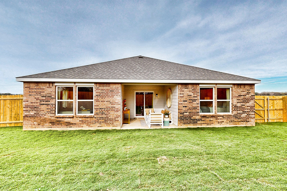 A house with a grass yard.