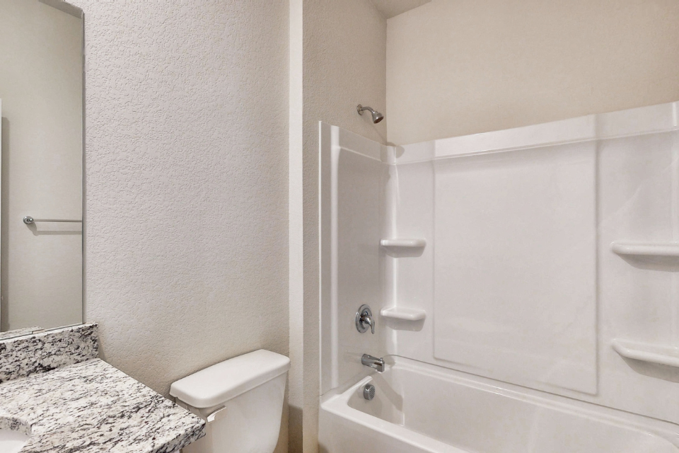 A bathroom with a marble countertop.