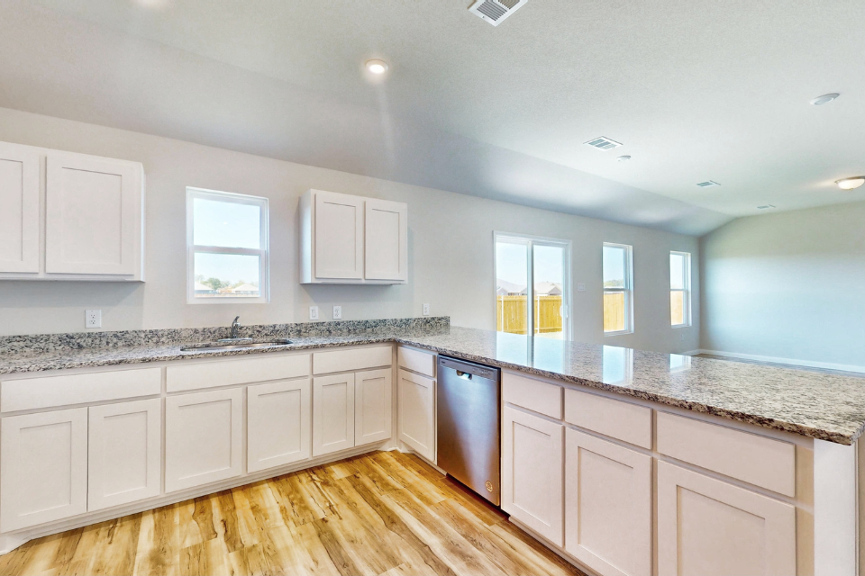 A kitchen with white cabinets.