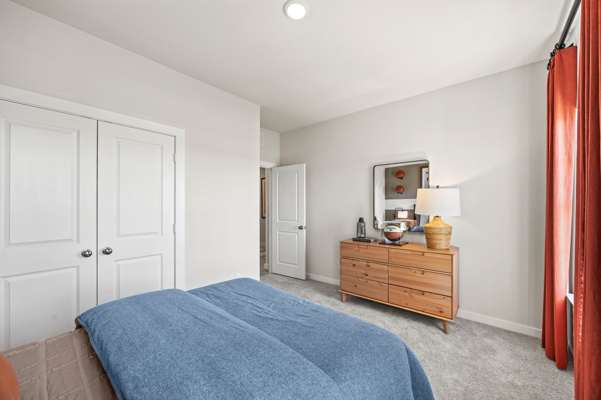 A bedroom with white doors.