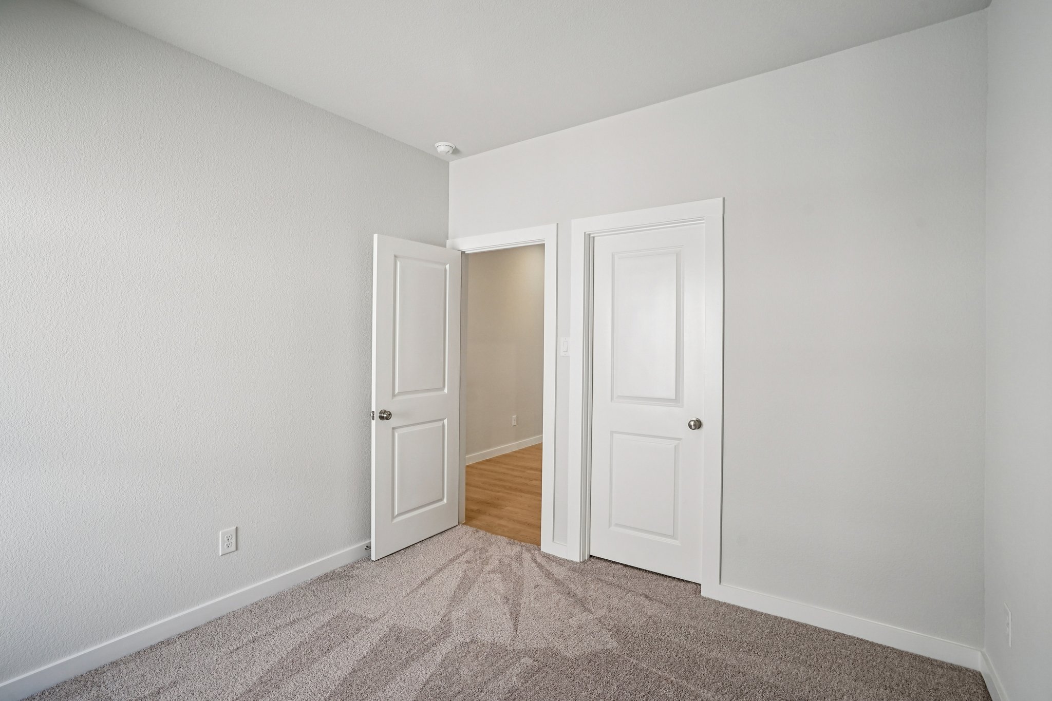 A hallway with white doors.