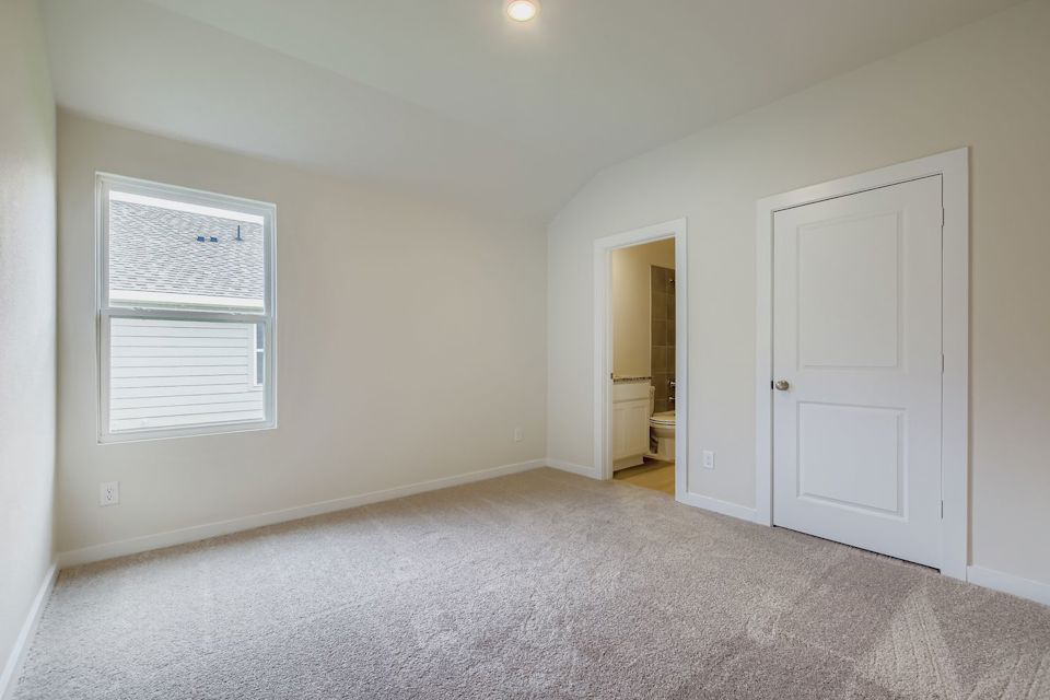 A room with white walls and a door.