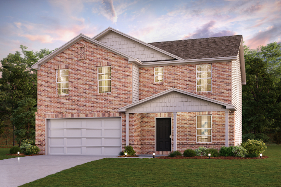 A brick house with a garage.
