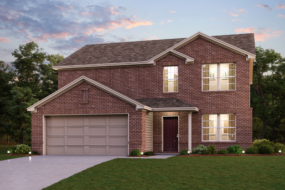 A brick house with a garage.