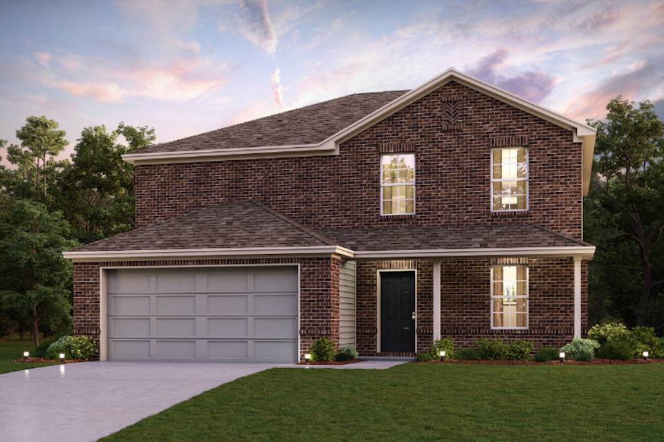 A brick house with a garage.
