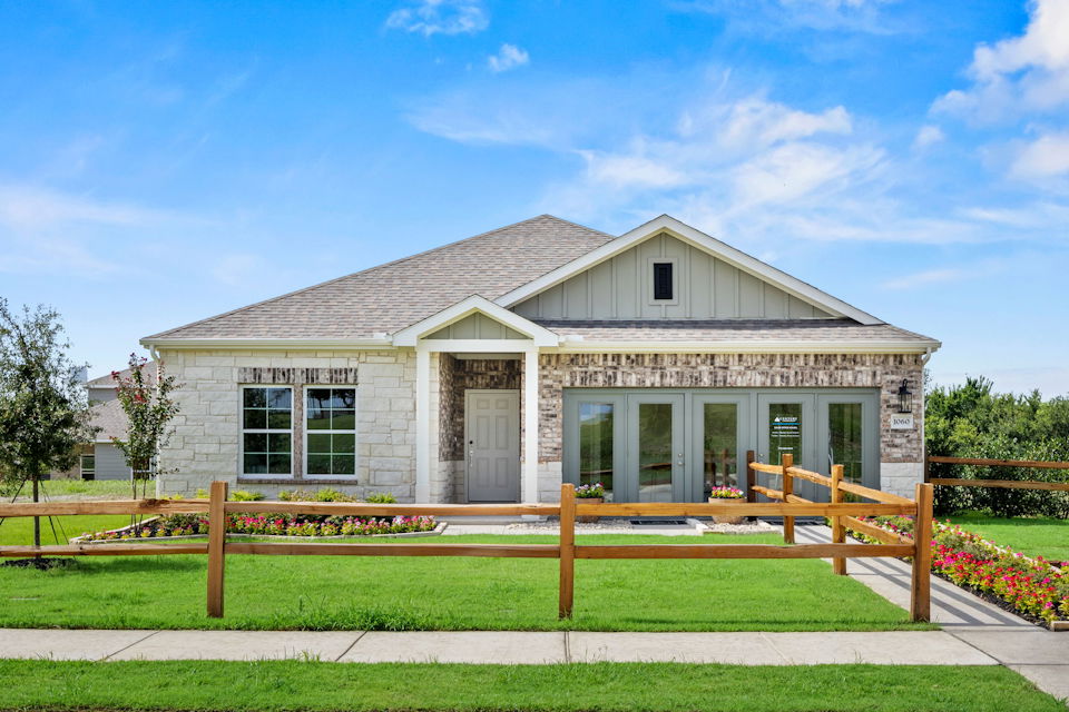 A house with a fence in front.