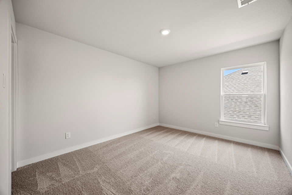 A room with a carpet and a sign on the wall.