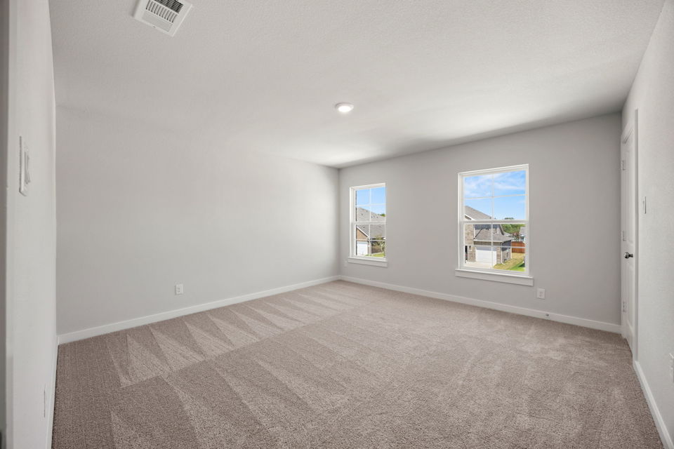 A room with a window and a carpet.