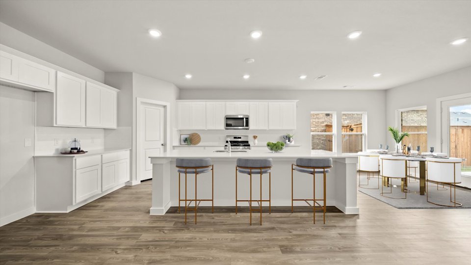 A kitchen with white cabinets.