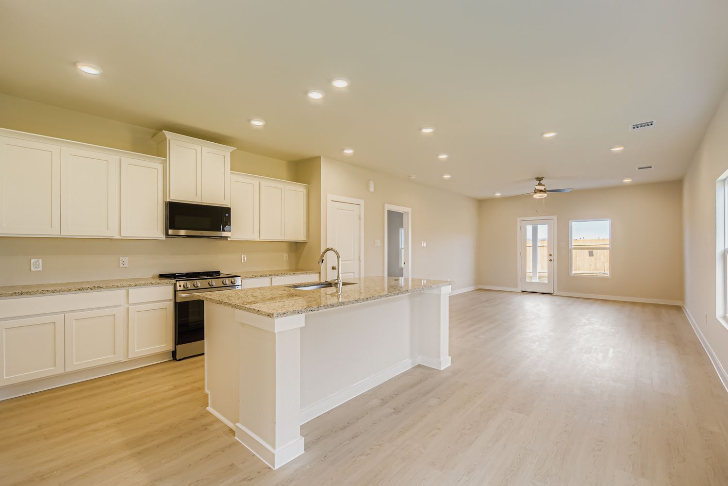 A large kitchen with white cabinets.