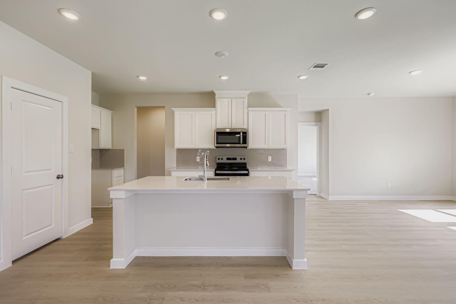 A large kitchen with white cabinets.