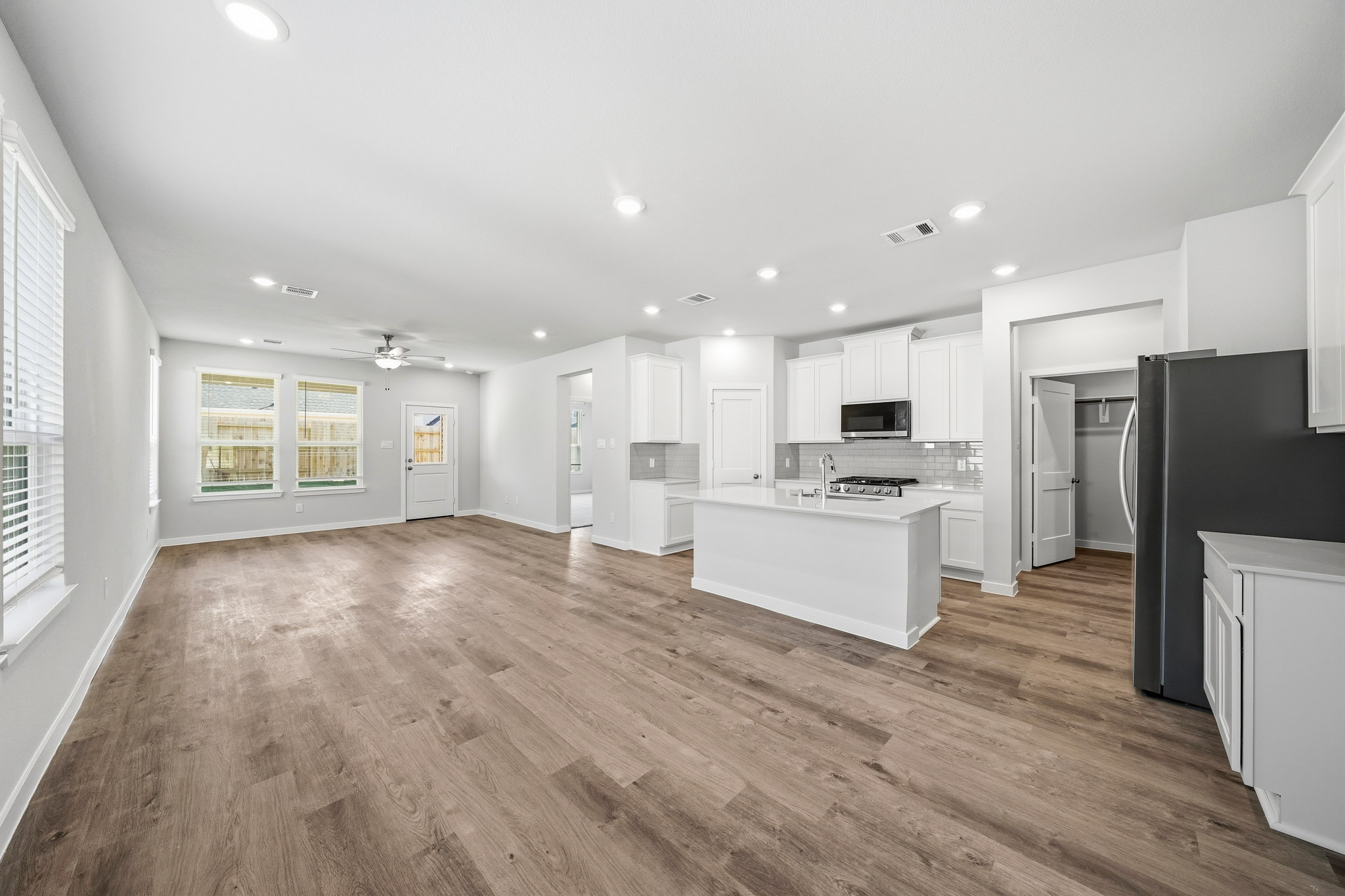 A large kitchen with white cabinets.